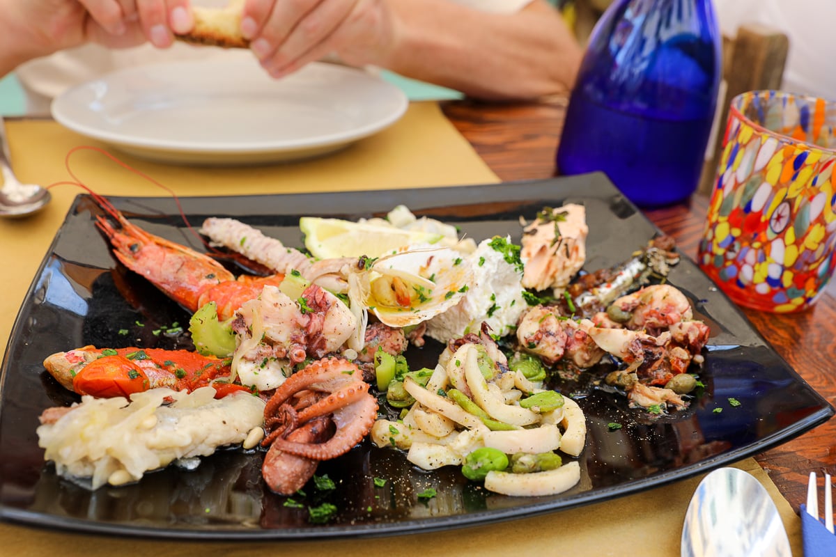 A colorful and delicous-looking mixed platter of fresh seafood in Venice. Dining at Il Paradiso Perduto is a must-add to your 2-day Venice itinerary.