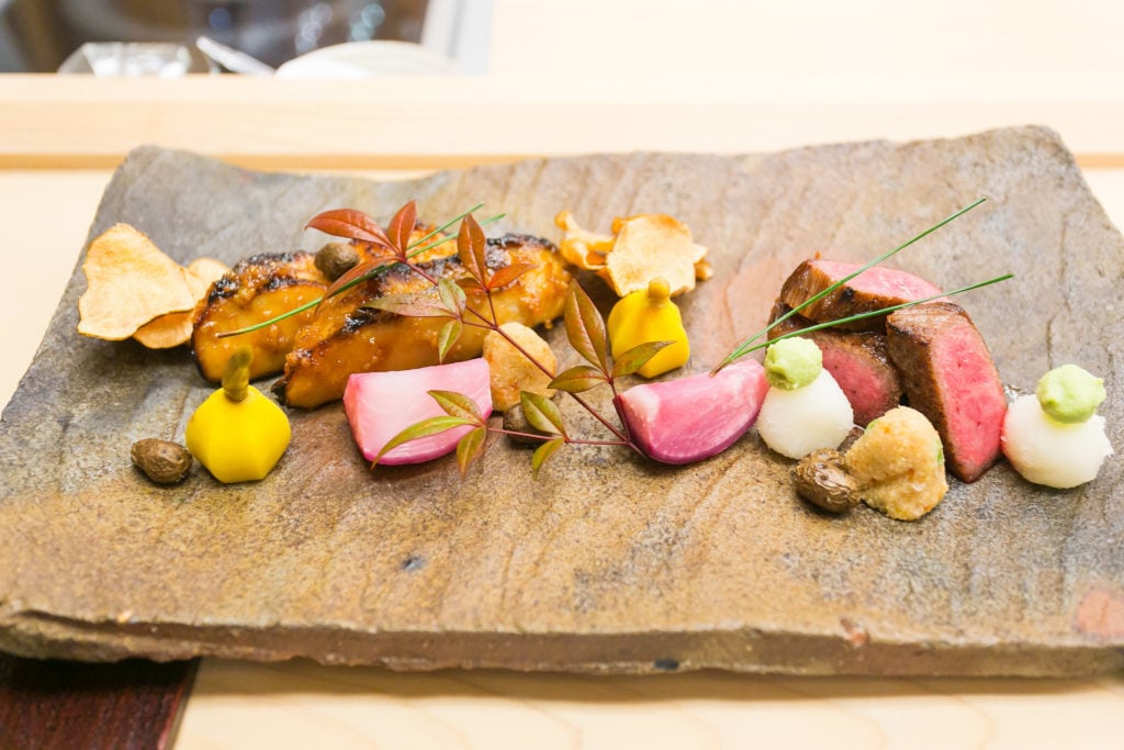 Kaiseki served on a plate. Wondering what to eat during your two days in Kyoto? This multi-course dinner is a must-try!